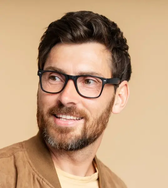 Bearded man wearing black rectangular glasses
